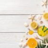 citrus fruits, iced cocktail, seashells and starfish on a white wooden background.