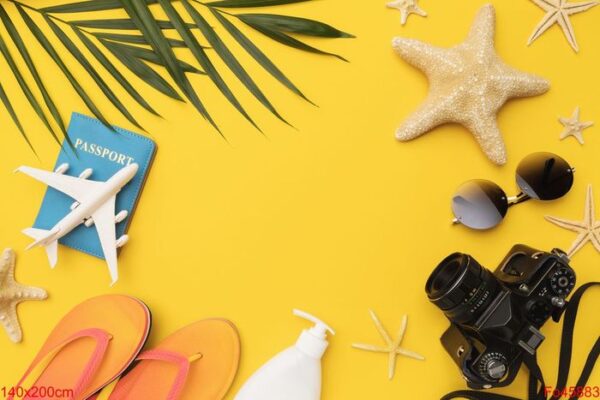 flat composition with beach holiday accessories on yellow backgr