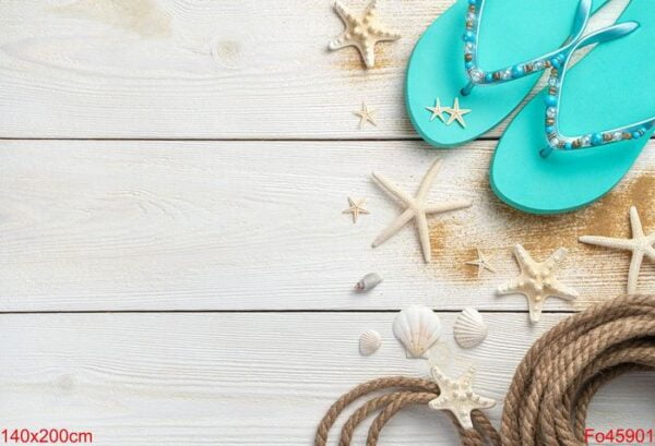 sea background with seashells, rope and summer flip flops on a white wooden background.