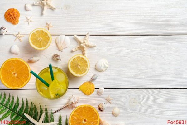 summer background with fruit and a cooling drink. oranges, lemons, juice and shells on a white background.