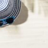 top view of hat on sand with and blue sunglasses