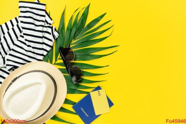 traveler accessories on yellow summer background. travel concept. copy space