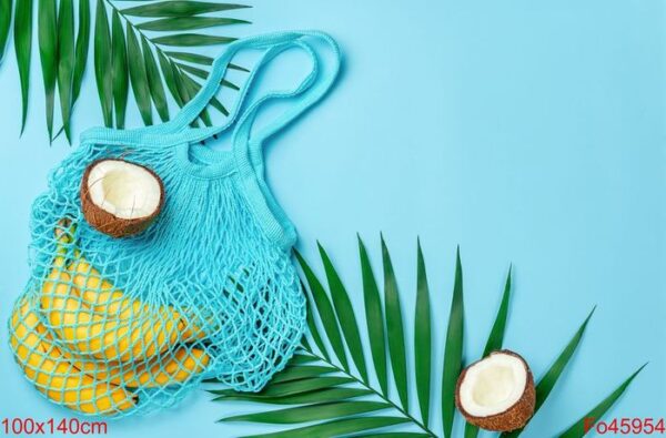 zero waste mesh bag with bananas and coconut on bright blue background. top view, copy space.