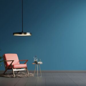 interior wall mockup in blue tones with red leather armchair on dark wall background.