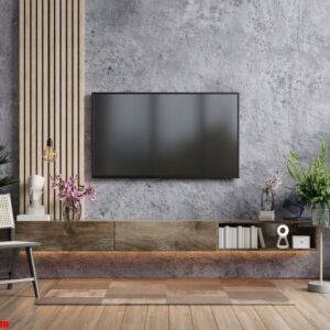 mockup a tv in modern living room with armchair and plant on concrete wall background.