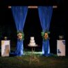 wedding cake on a wooden bench against a waterfall background