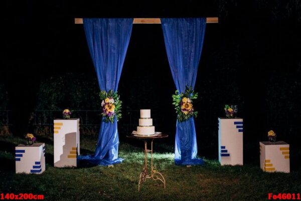 wedding cake on a wooden bench against a waterfall background