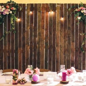 wedding venue. wooden wall at the banquet table with lamps and flowers. copy space