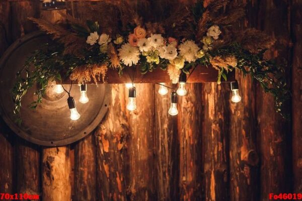 the wooden wall is decorated with electric lamps and flowers. wedding decorations rustic