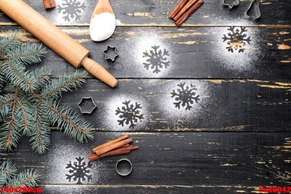 christmas composition with cookie cutters and flour on dark wooden background