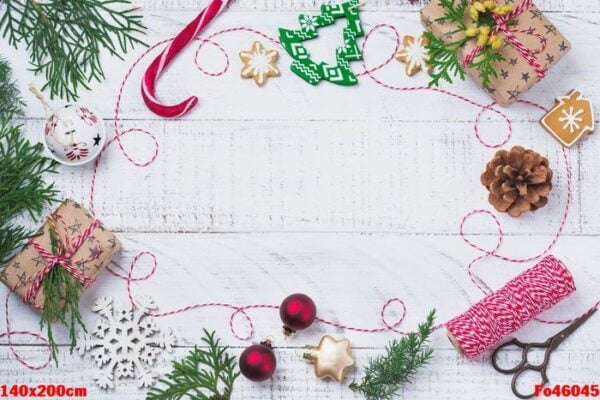 christmas background with fir branches, toys, gift box and bells on wooden old background table. selective focus. top view with copy space