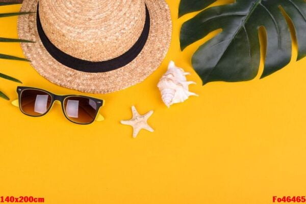 beach accessories: glasses and hat with shells and sea stars on a colored background