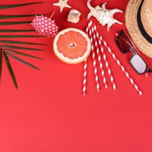 beach accessories with shells and sea stars on a colored background