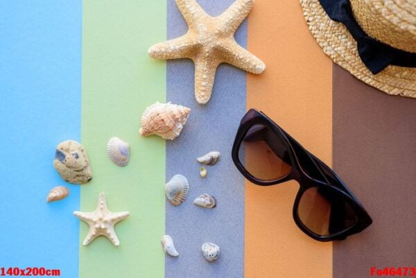 beach accessories: glasses and hat with shells and sea stars on a colored background