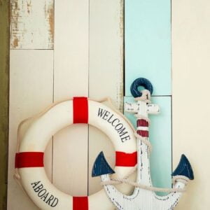 composition on the marine theme with anchor and lifeline on wooden background