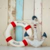 composition on the marine theme with anchor and lifeline on wooden background