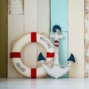 composition on the marine theme with anchor and lifeline on wooden background