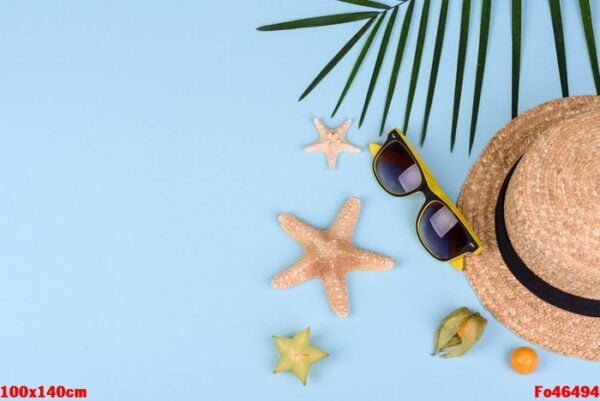 fruit carambol, beach accessories and foliage of a tropical plant on colored paper