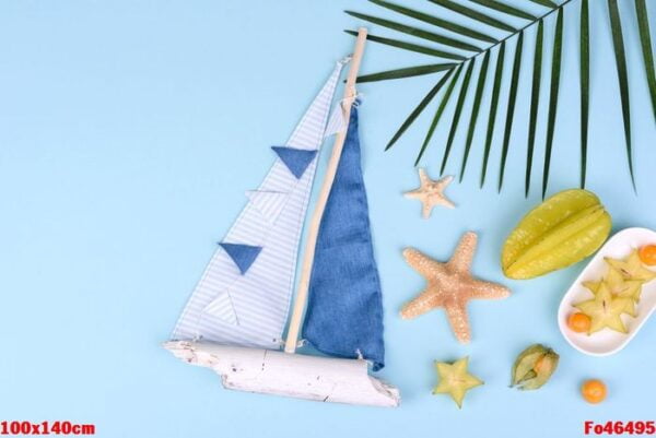 fruit carambol, beach accessories and foliage of a tropical plant on colored paper