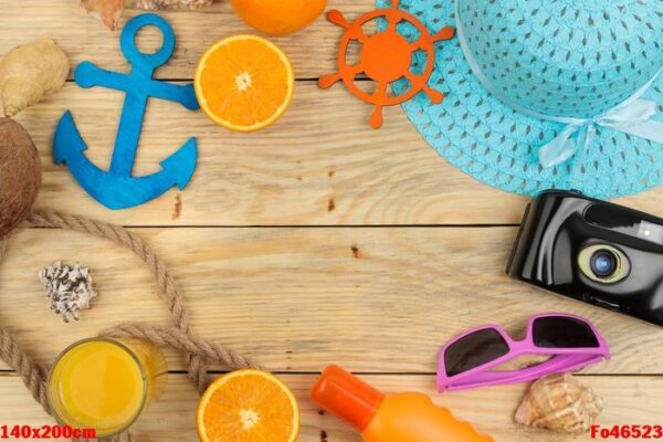 summer accessories. beach accessories. hat, sunscreen, sunglasses, camera, and orange on a natural wooden table. top view. space for text