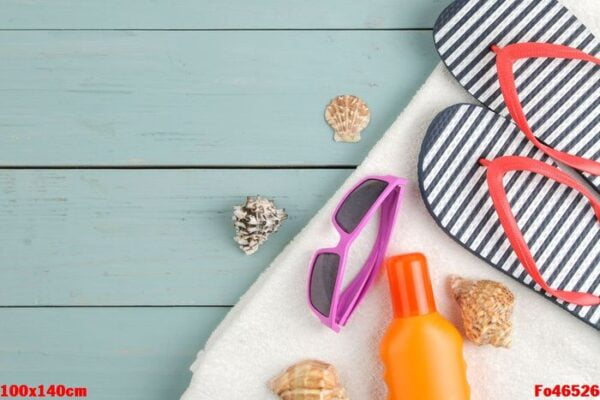 summer accessories. beach accessories. slaps, towel, and sunglasses on a blue wooden table. top view. place for text.