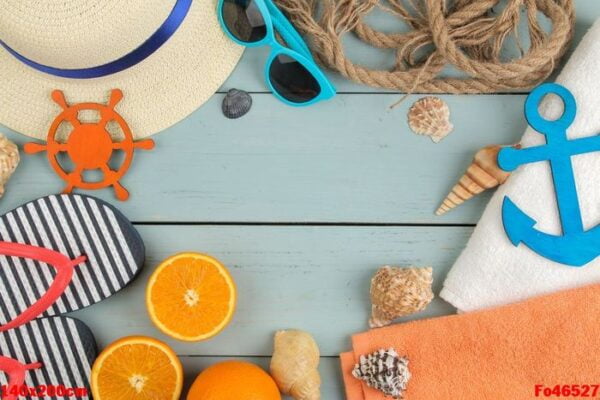 summer accessories. beach accessories. slippers, hat, shells, towel, and sunglasses on a blue wooden table. top view.