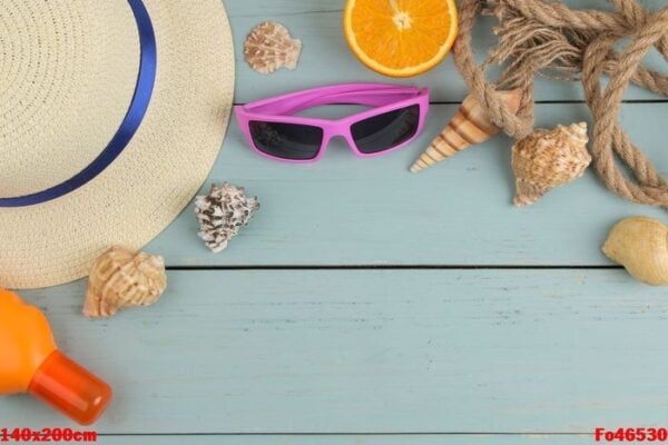 summer accessories. beach accessories. sunscreens, a hat, shells, and sunglasses on a blue wooden table. top view. place for text.