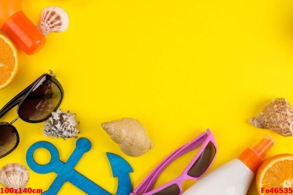 summer accessories with shells, sun glasses, orange and coconut on a bright yellow background. top view. space for text