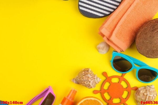 summer accessories with shells, sun glasses, orange and coconut on a bright yellow background. top view. space for text