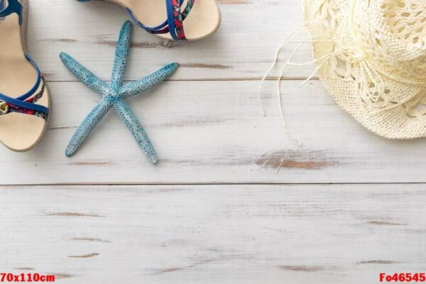 summer background concept: female sandals, starfish, straw hat on light wooden surface