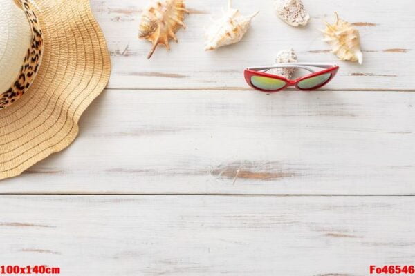 summer background concept: straw hat, seashells, sunglasses on light wooden surface