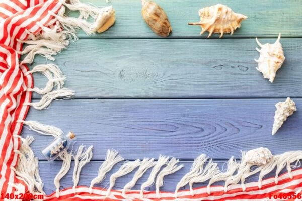 summer background: fringed pareos, seashells on a blue wooden background