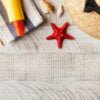 summer background. hat, seashells, sunscreen on a wooden background. copy space.