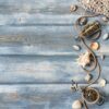 summer interior decoration with starfishes, seashells, ropes and stones on blue wooden background. copy space. still life. flat lay