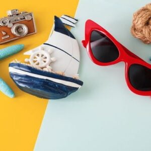 sunglasses and accessories on yellow and blue background