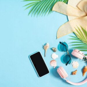 top view photo of beach accessories on a blue background