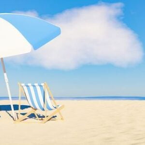 umbrella with flamingo float and chair on the sandy beach