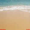 soft blue ocean wave on sandy beach.