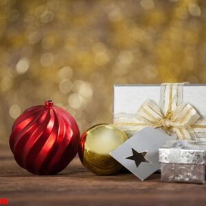 wrapped gift box and baubles on wooden table