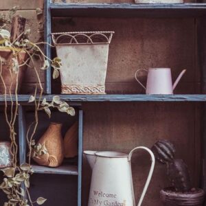 garden tools and flowerpots on wood shelf background with vintage feel