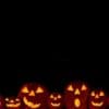 happy halloween pumpkins lined up in a row in a black background.