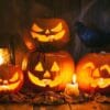 halloween jack o lantern pumpkins on rustic wooden background