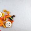 halloween background with cookies, pumpkin, leaves