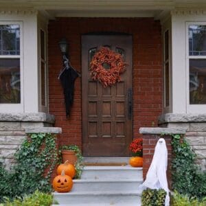 front,porch,of,house,with,halloween,decorations,and,wreath,on