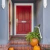 red,front,door,with,pumpkins,along,the,steps