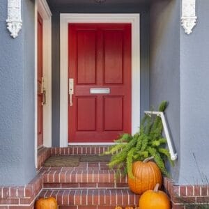 red,front,door,with,pumpkins,along,the,steps