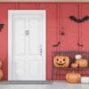 carved,pumpkins,,bats,and,spiders,near,white,front,door,of