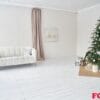 modern home decor for christmas. with a space to copy. stylish interior of the living room with a white sofa and a christmas tree.