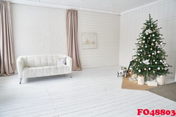 modern home decor for christmas. with a space to copy. stylish interior of the living room with a white sofa and a christmas tree.