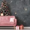 stylish pink sofa decorated for christmas with christmas tree and ornaments